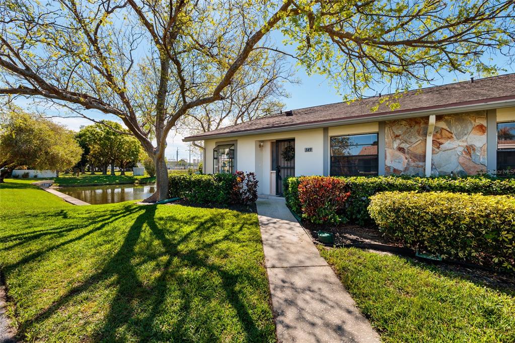 a front view of house with yard and green space