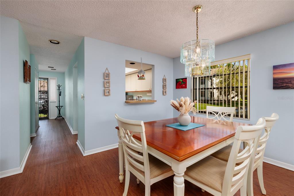 1601 43rd Street, Unit 149 St. Petersburg, FL 33713 - Photo 11 of 51 a dining room with furniture a chandelier and wooden floor