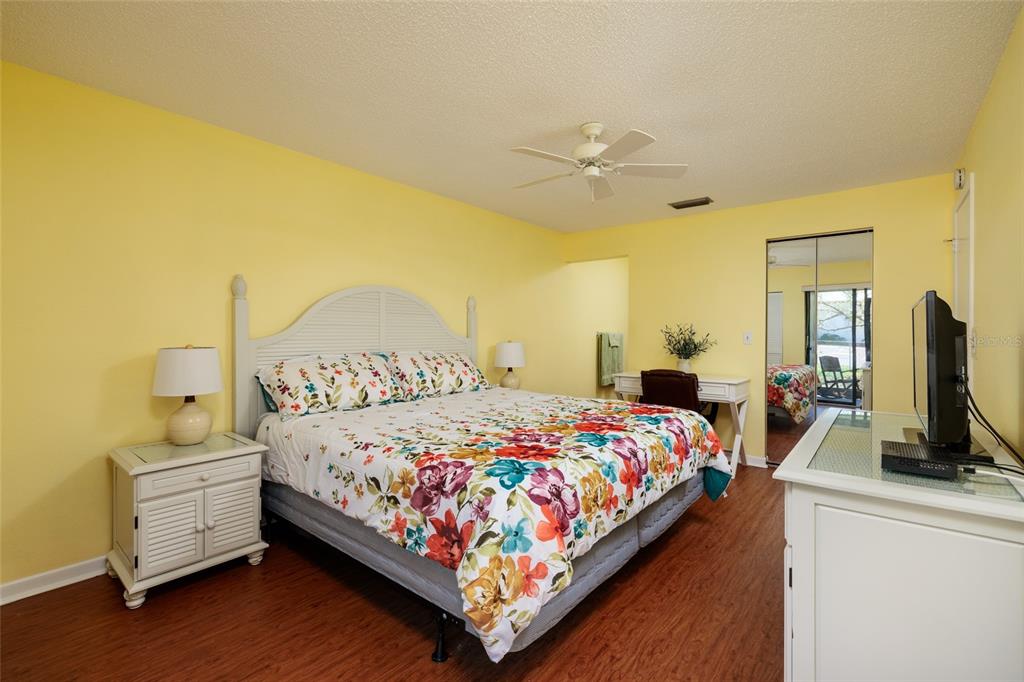 1601 43rd Street, Unit 149 St. Petersburg, FL 33713 - Photo 15 of 51 a bedroom with a bed and a flat tv screen on dresser