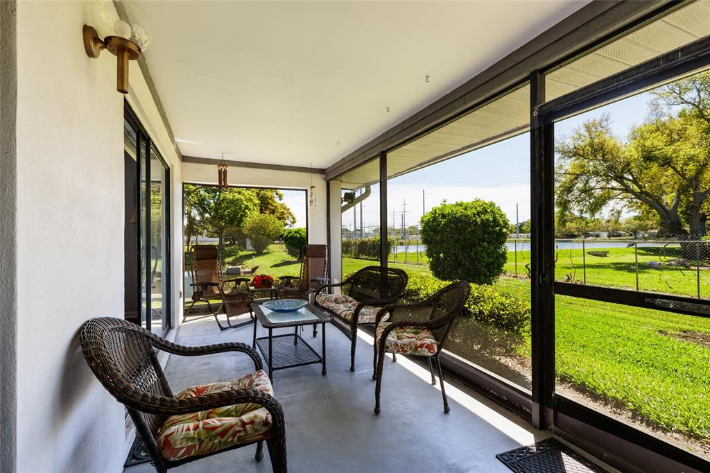 1601 43rd Street, Unit 149 St. Petersburg, FL 33713 - Photo 18 of 51 a living room with patio floor to ceiling windows and a floor to ceiling window