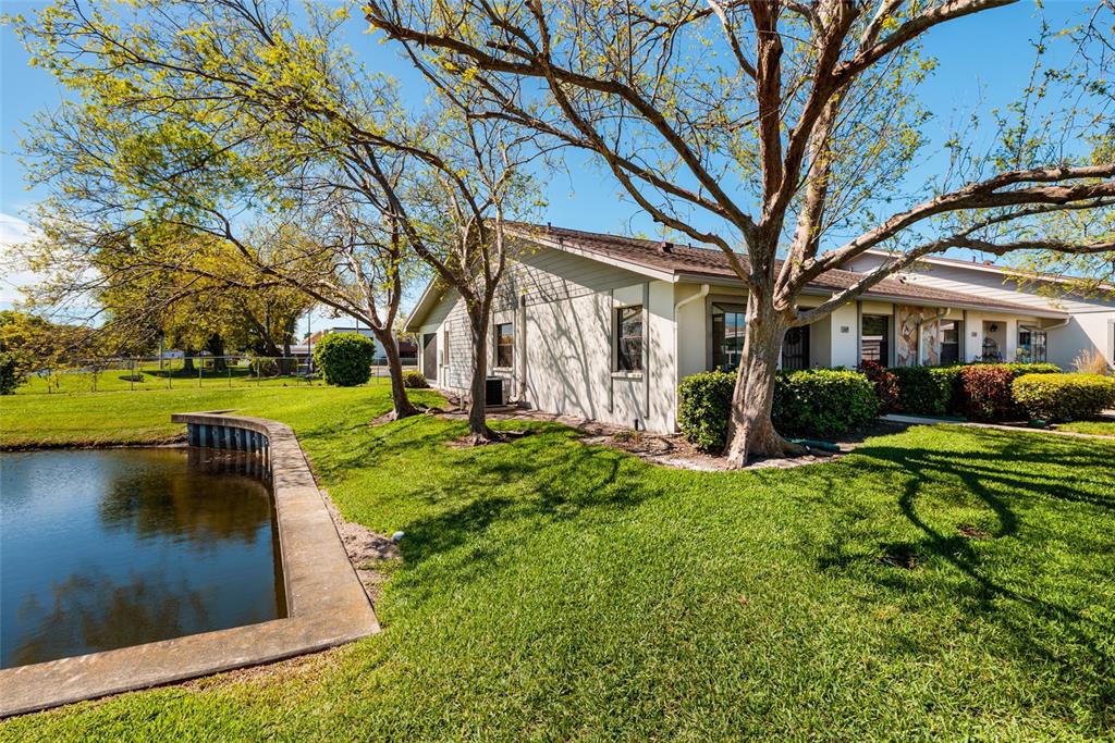 1601 43rd Street, Unit 149 St. Petersburg, FL 33713 - Photo 2 of 51 a view of a yard with plants and a fountain