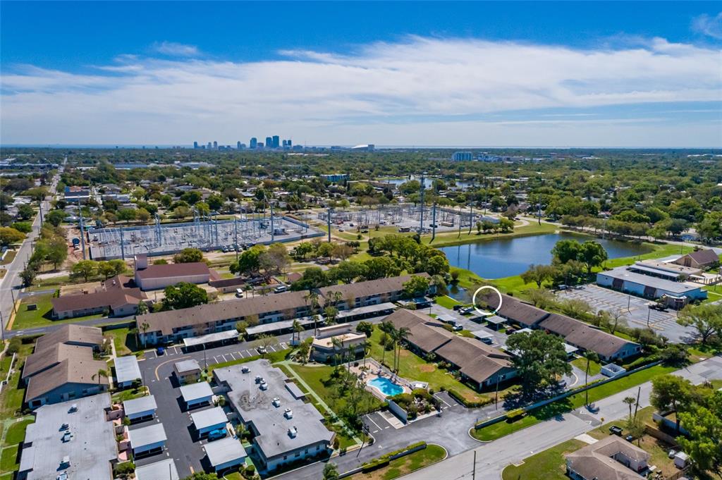 1601 43rd Street, Unit 149 St. Petersburg, FL 33713 - Photo 27 of 51 an aerial view of a city with lots of residential buildings and ocean view in back