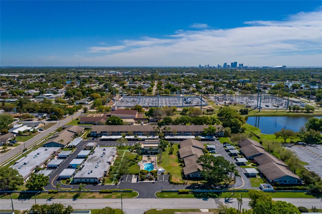 1601 43rd Street, Unit 149 St. Petersburg, FL 33713 - Photo 38 of 51 an aerial view of a city with lots of residential buildings ocean and mountain view in back