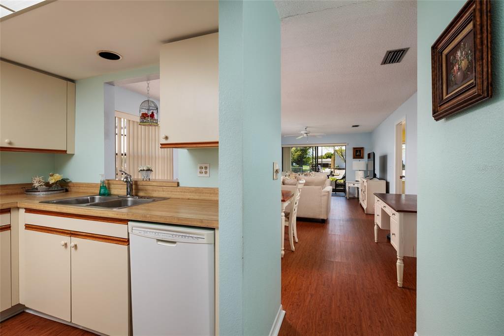 1601 43rd Street, Unit 149 St. Petersburg, FL 33713 - Photo 5 of 51 a view of a kitchen with a sink dishwasher stove and wooden cabinets