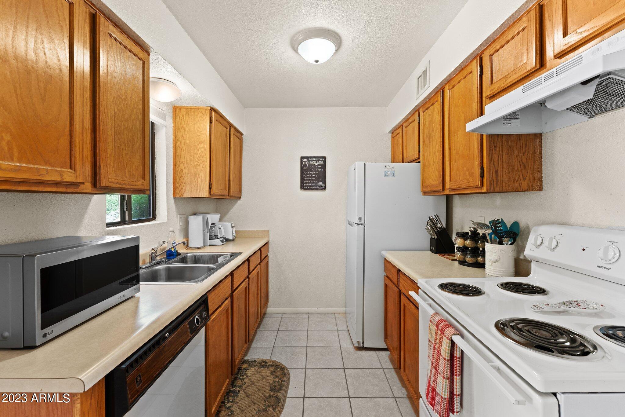 540 South West Road, Unit 26 Wickenburg, AZ 85390 - Photo 4 of 14 a kitchen with a sink a stove and cabinets