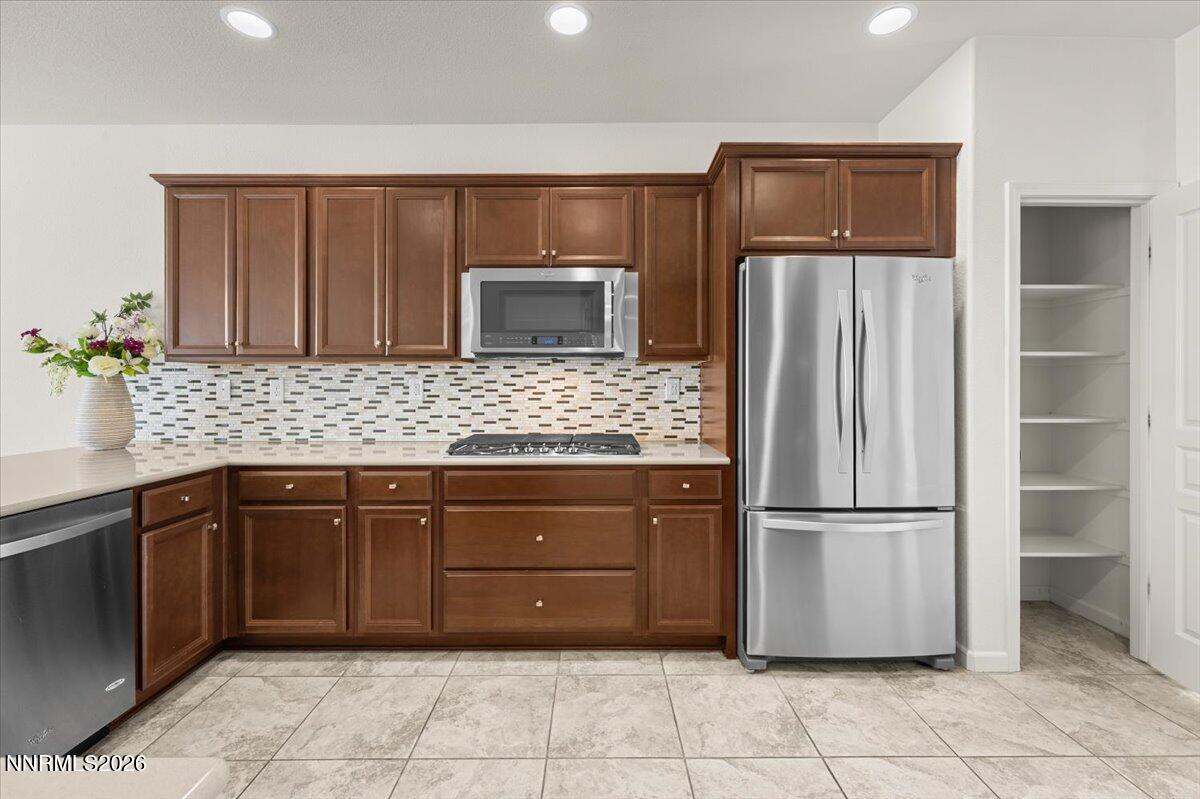 9225 Sassafras Trail Reno, NV 89523 - Photo 16 of 65 a kitchen with stainless steel appliances granite countertop a refrigerator and a sink