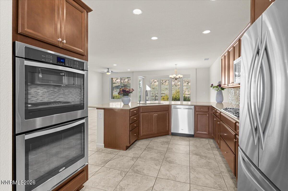 9225 Sassafras Trail Reno, NV 89523 - Photo 17 of 65 a kitchen with a refrigerator sink and cabinets