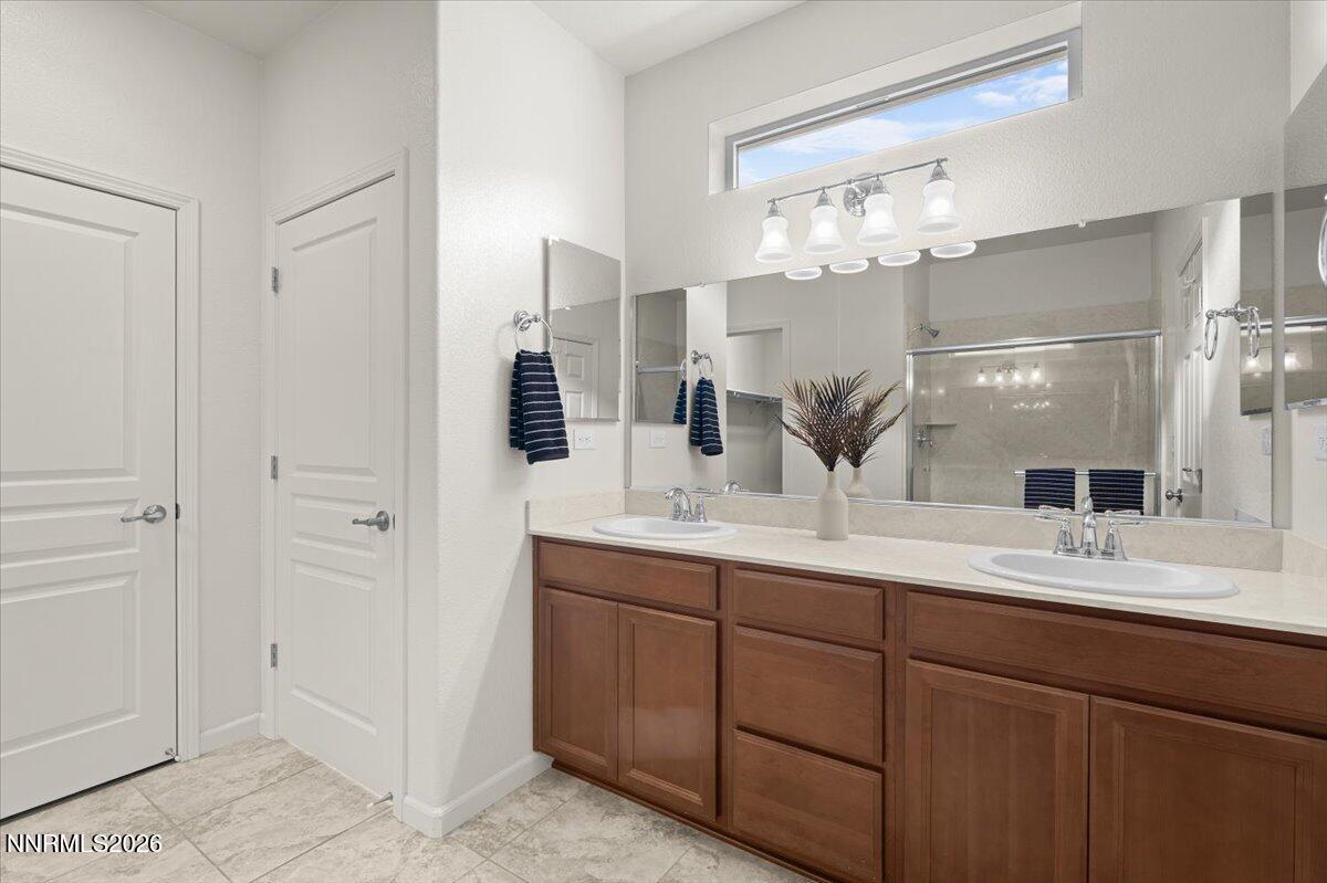 9225 Sassafras Trail Reno, NV 89523 - Photo 24 of 65 a bathroom with a double vanity sink and a mirror