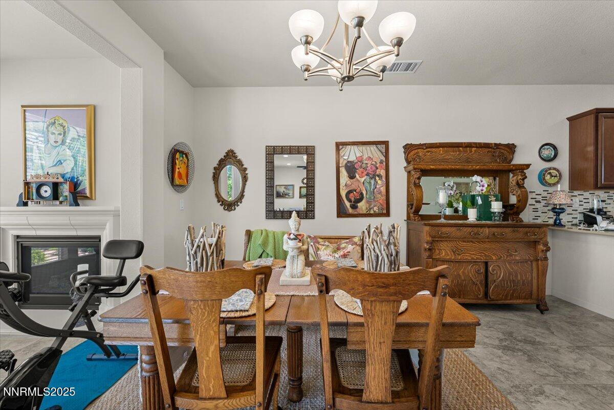 9225 Sassafras Trail Reno, NV 89523 - Photo 35 of 65 a view of a dining room with furniture and chandelier