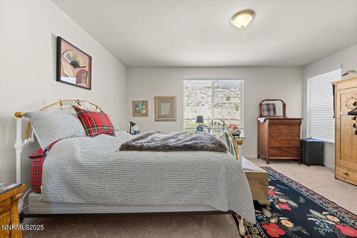 9225 Sassafras Trail Reno, NV 89523 - Photo 46 of 65 a bedroom with a bed and a television