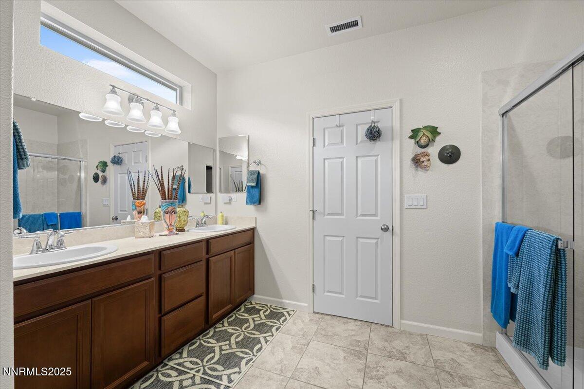 9225 Sassafras Trail Reno, NV 89523 - Photo 47 of 65 a bathroom with a double vanity sink mirror and shower