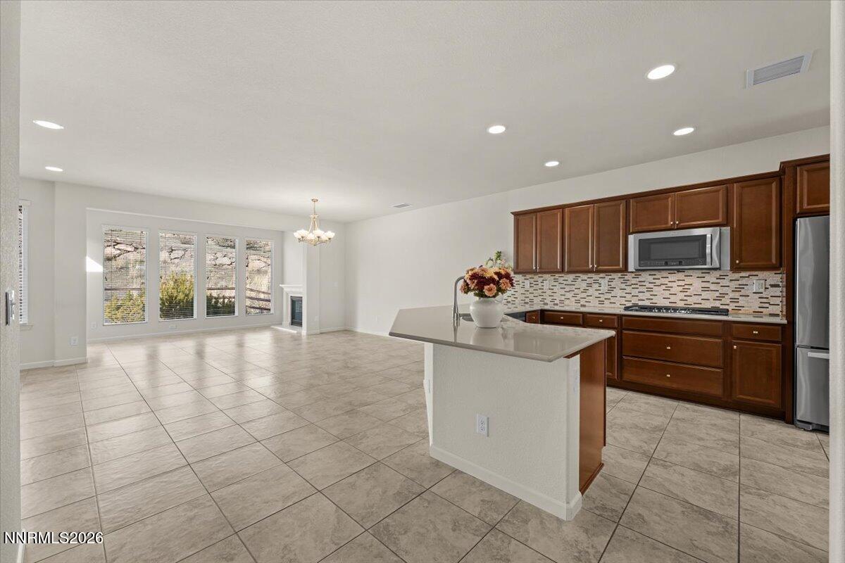 9225 Sassafras Trail Reno, NV 89523 - Photo 6 of 65 a large kitchen with stainless steel appliances kitchen island granite countertop a sink and cabinets