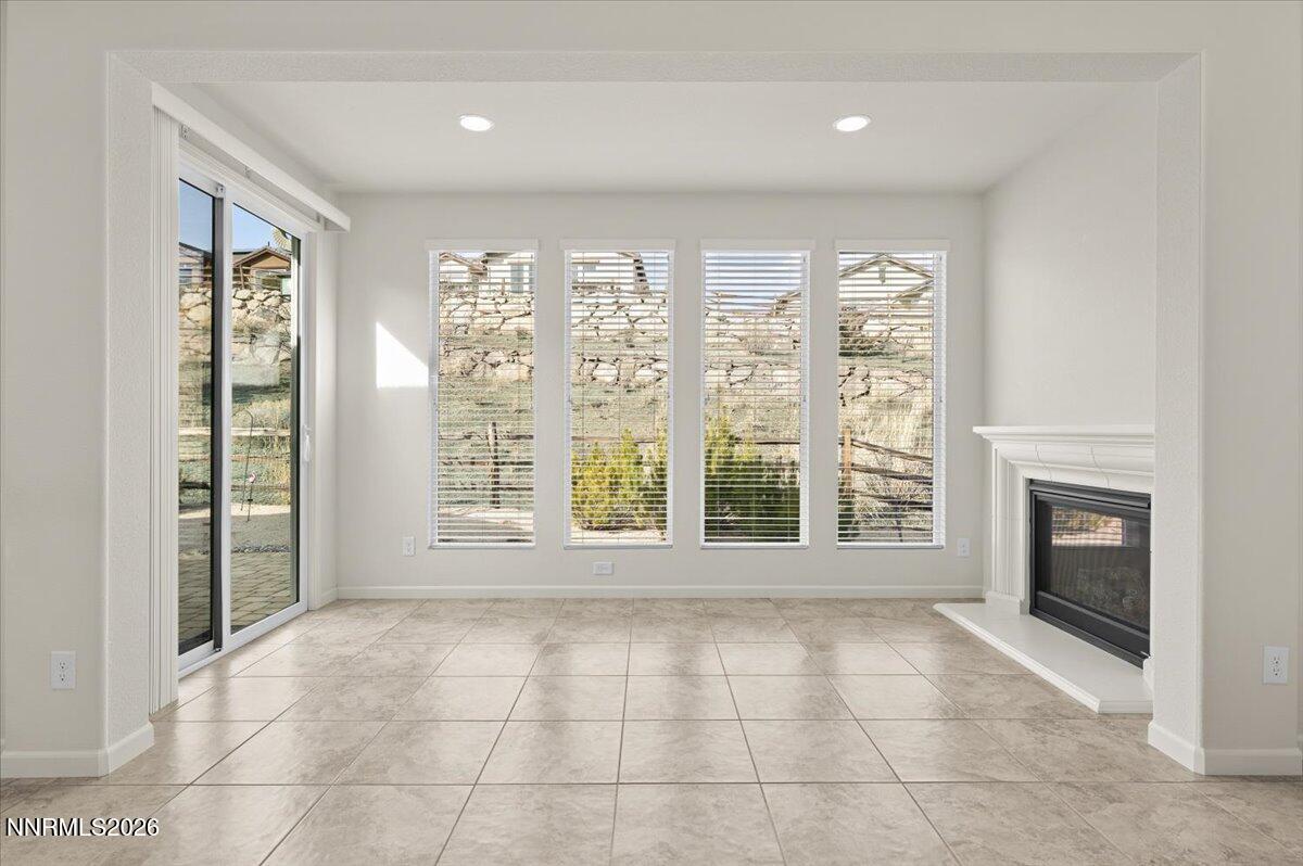 9225 Sassafras Trail Reno, NV 89523 - Photo 9 of 65 a view of an empty room with a fireplace and a window