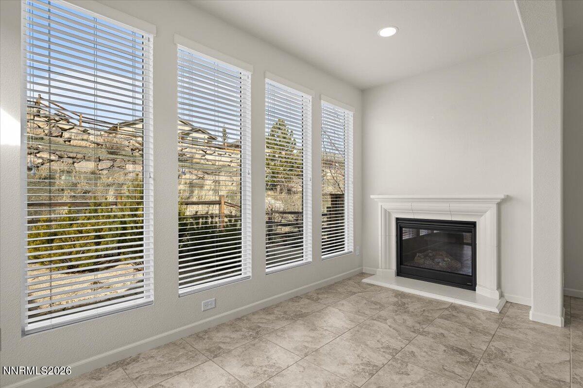 9225 Sassafras Trail Reno, NV 89523 - Photo 10 of 65 a view of an empty room with a fireplace and a window