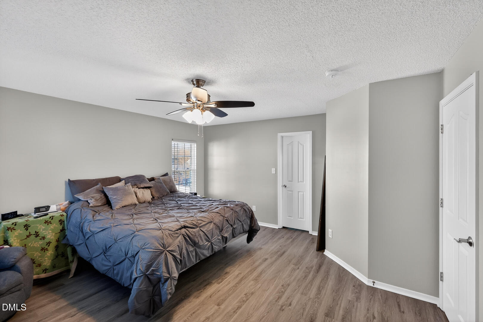 5709 Apalachicula Drive Raleigh, NC 27616 - Photo 17 of 47 a bedroom with a bed and wooden floor