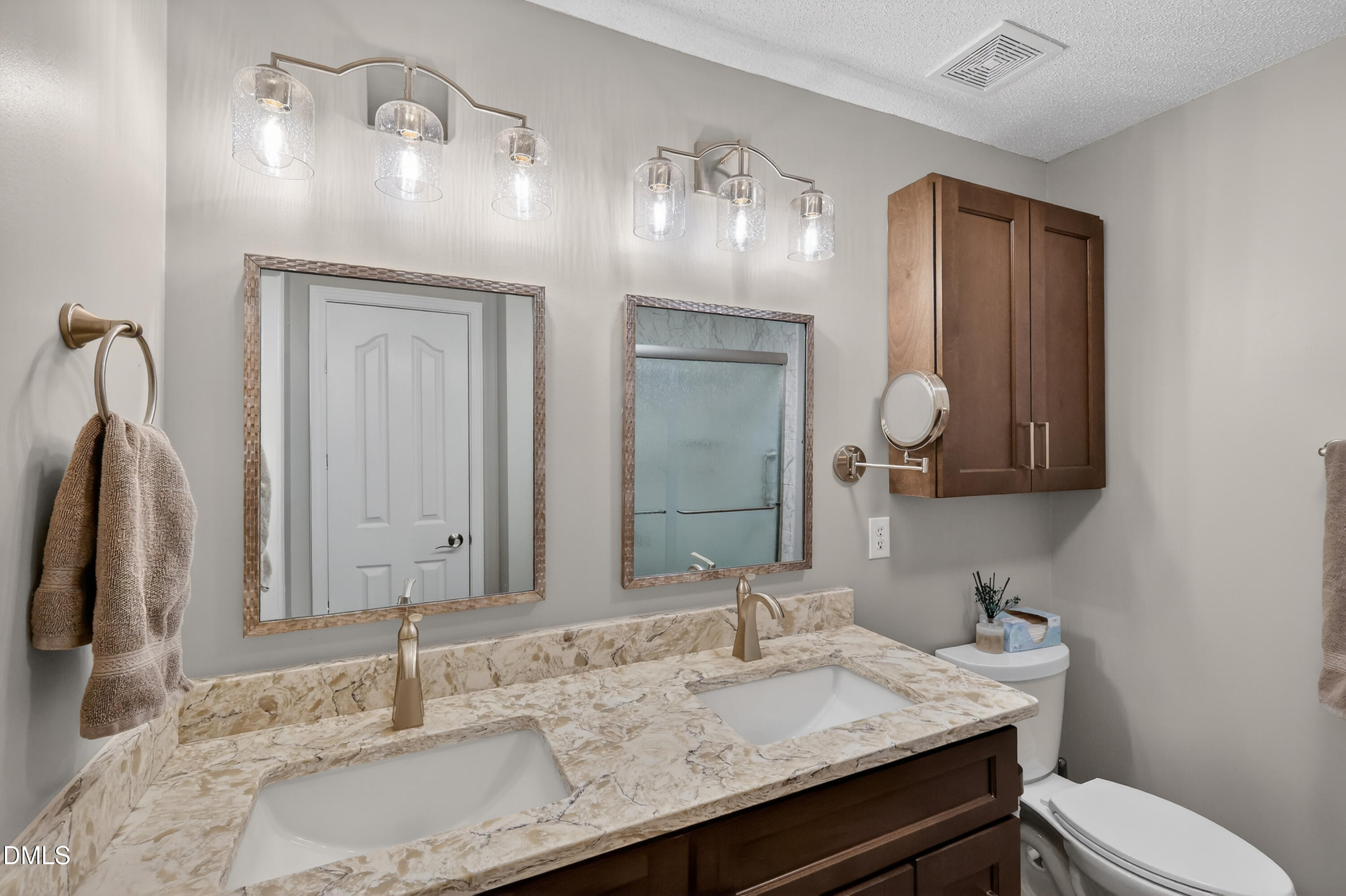 5709 Apalachicula Drive Raleigh, NC 27616 - Photo 18 of 47 a bathroom with a granite countertop double vanity sink and a mirror