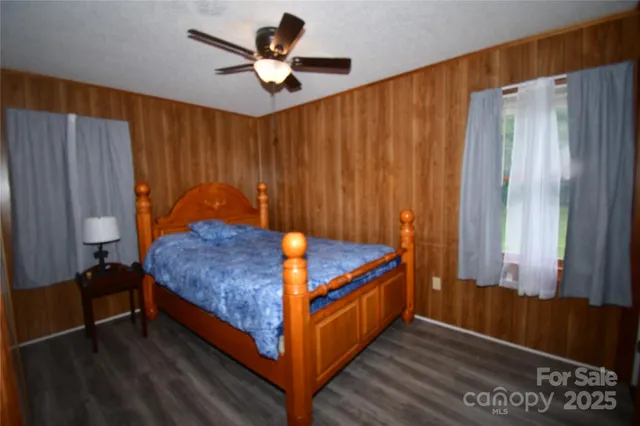 a blue bed sitting in a bedroom next to a window