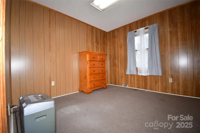 a view of an empty room with closet area