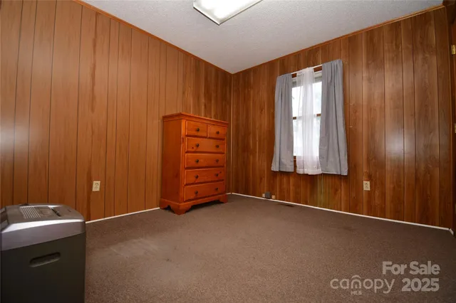 a view of an empty room with a cabinet