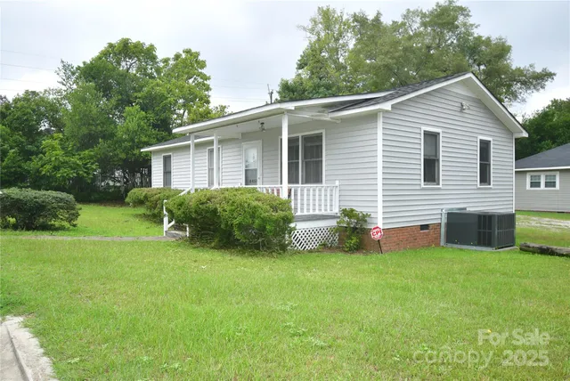 a view of a house with a yard and deck