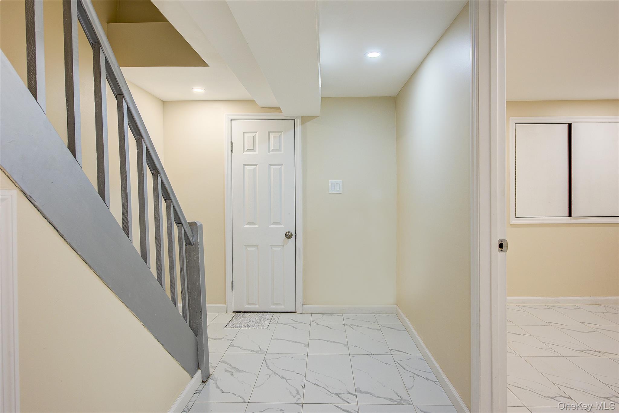 164-38 76th Road Queens, NY 11366 - Photo 35 of 44 a view of a hallway with wooden floor and staircase