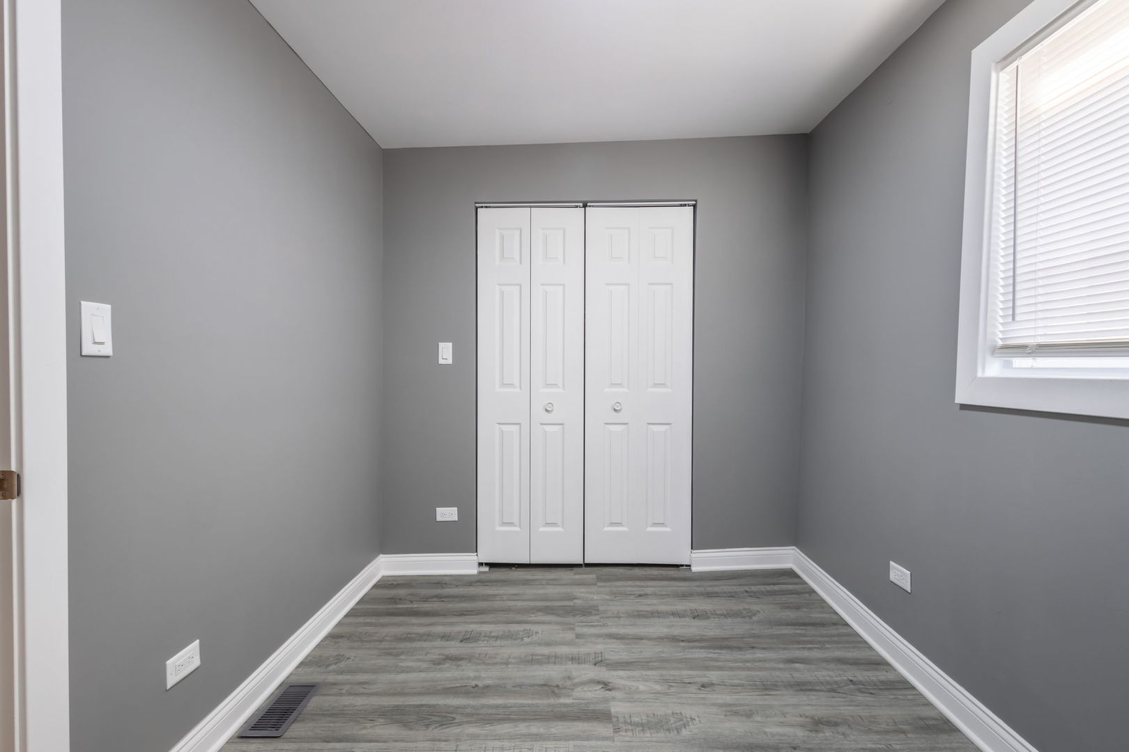 6830 South Honore Street Chicago, IL 60636 - Photo 11 of 31 an empty room with wooden floor and windows