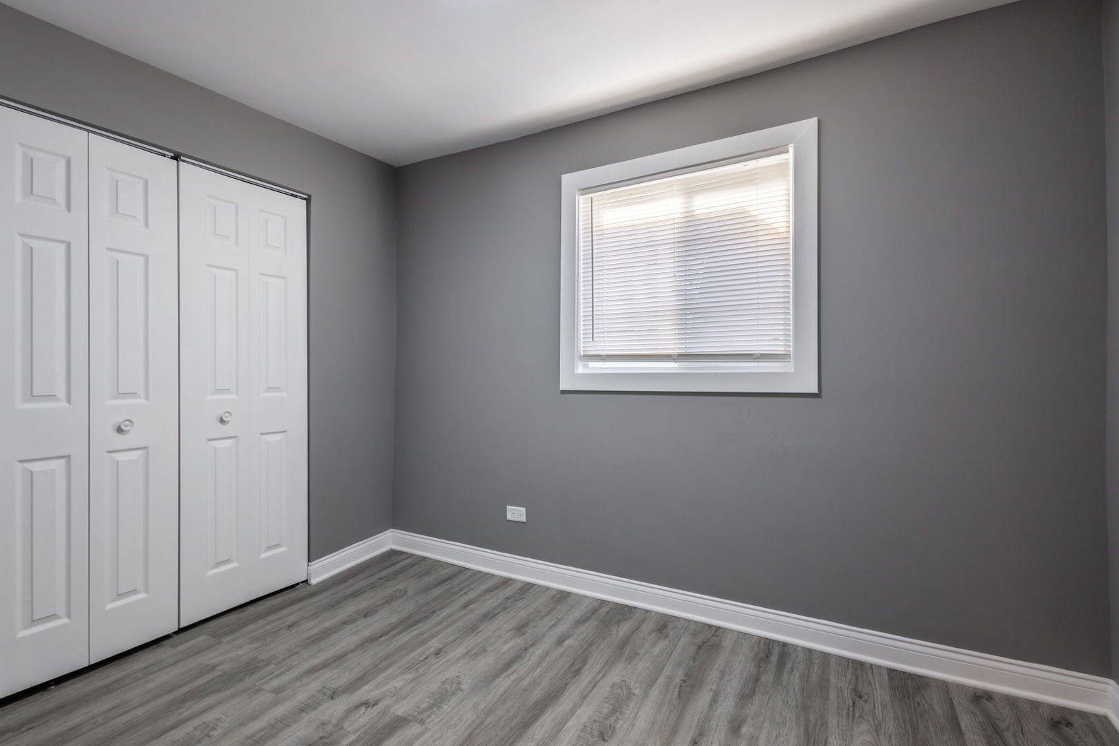 6830 South Honore Street Chicago, IL 60636 - Photo 12 of 31 an empty room with wooden floor and windows