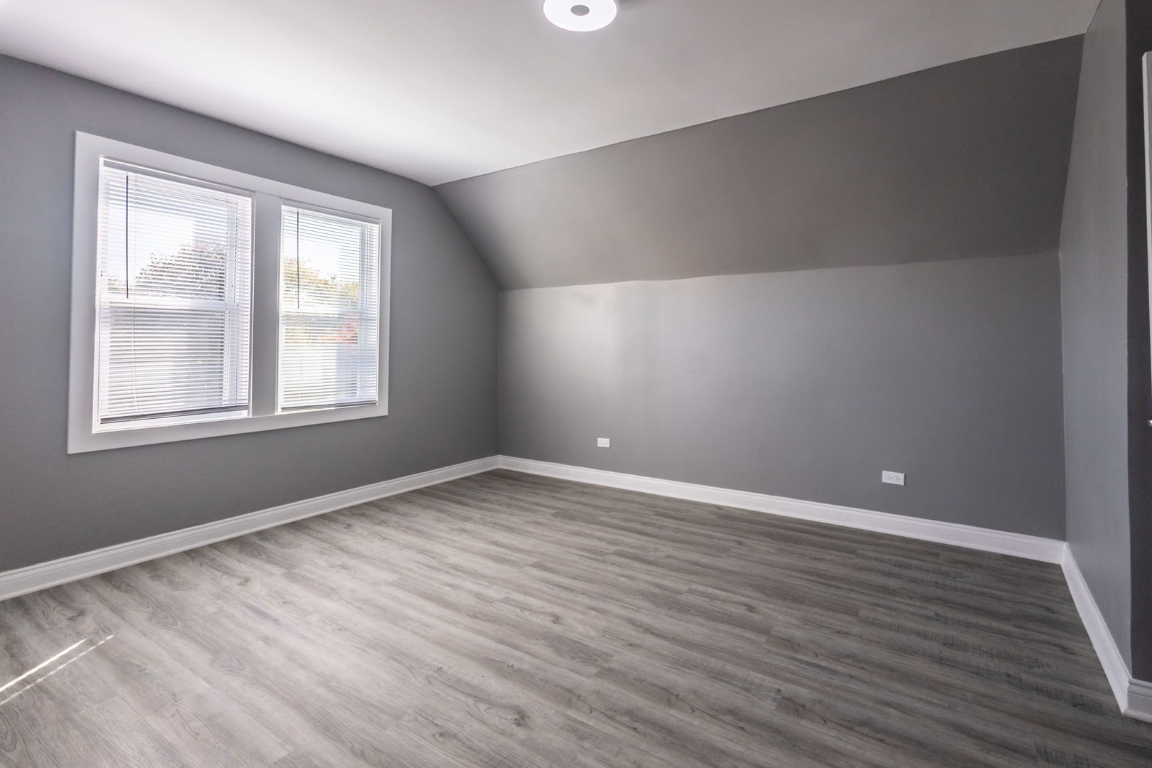 6830 South Honore Street Chicago, IL 60636 - Photo 17 of 31 a view of an empty room with wooden floor and a window