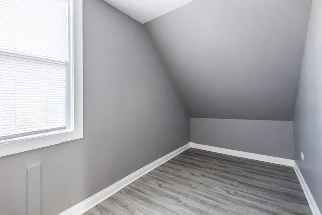 a view of a small space with wooden floor and a window