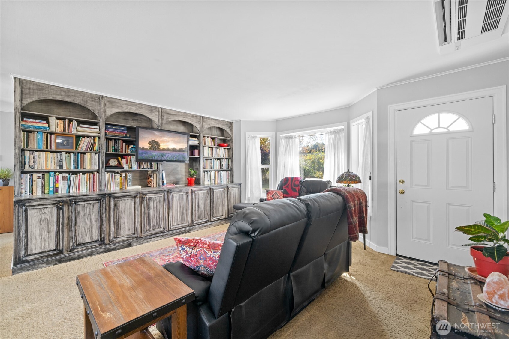 1330 Thornton Drive Sequim, WA 98382 - Photo 11 of 39 a living room with furniture a rug and a book shelf