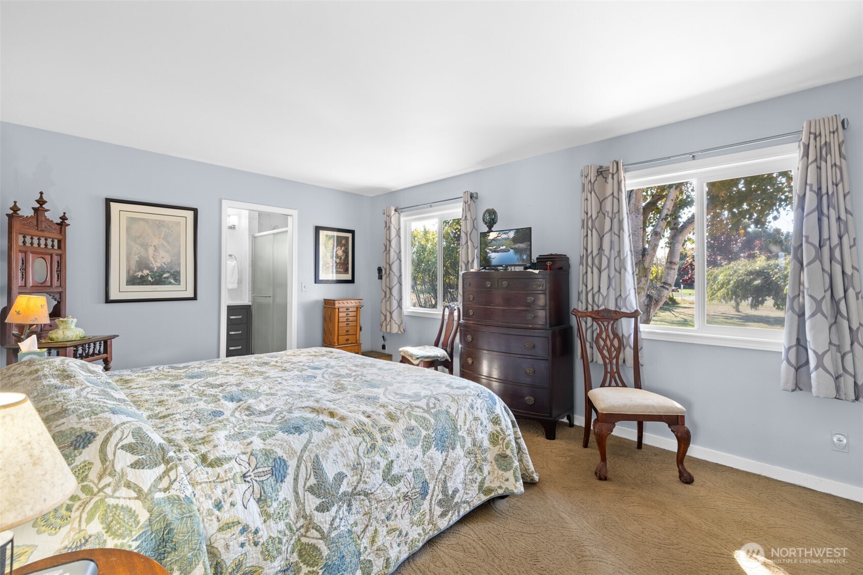 1330 Thornton Drive Sequim, WA 98382 - Photo 15 of 39 a bedroom with a bed and a chair