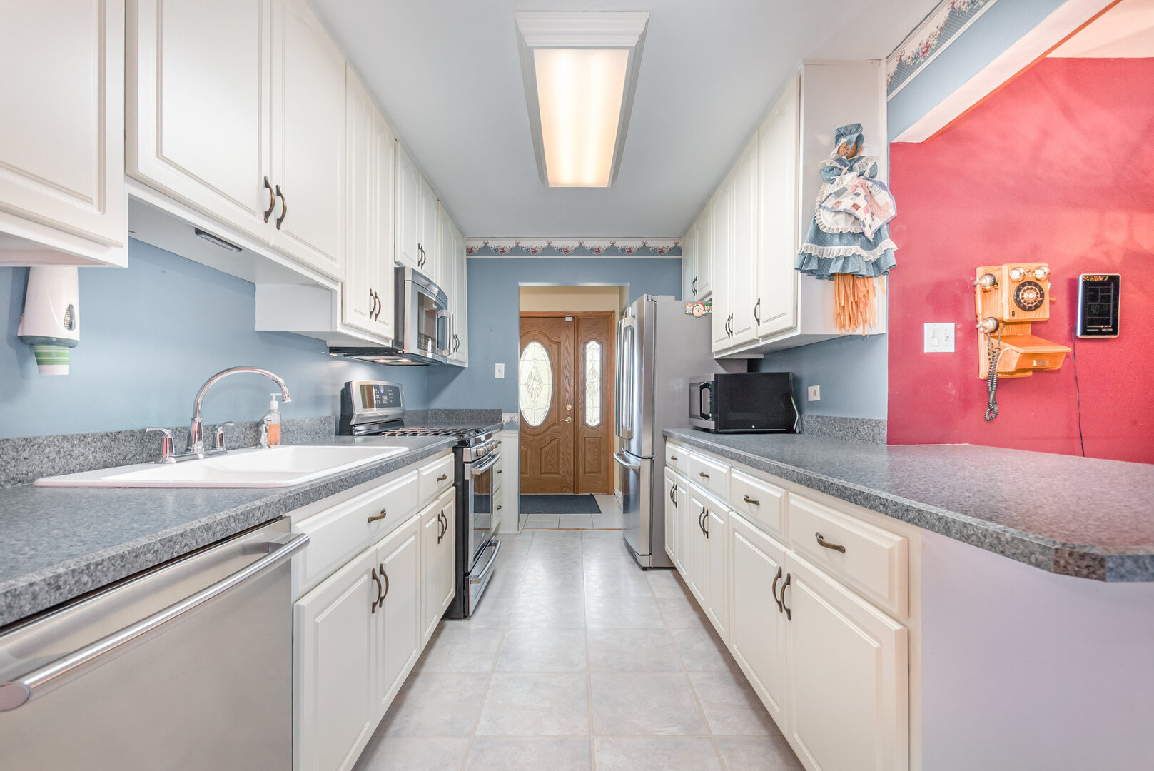 15200 Pine Drive Oak Forest, IL 60452 - Photo 7 of 20 a kitchen with granite countertop a sink stainless steel appliances and cabinets