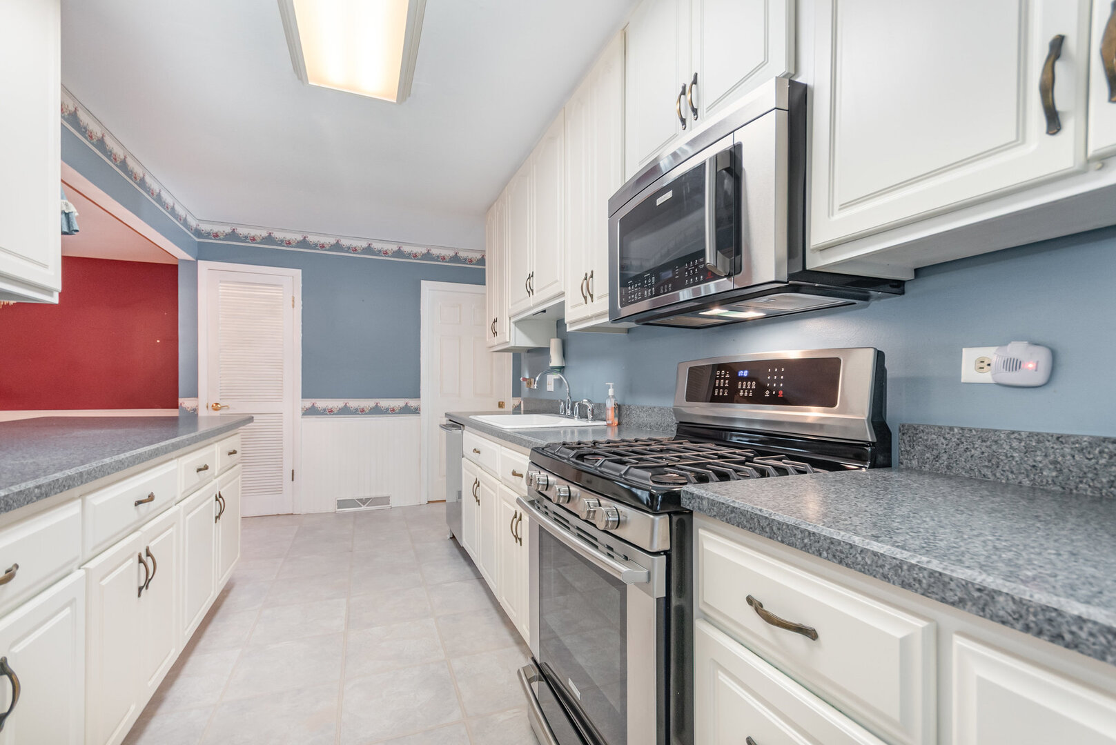15200 Pine Drive Oak Forest, IL 60452 - Photo 8 of 20 a kitchen with stainless steel appliances granite countertop a stove a sink and a microwave
