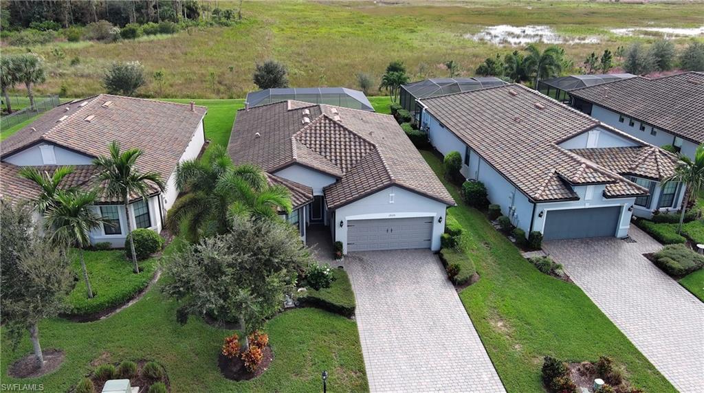 19375 Elston Way Estero, FL 33928 - Photo 3 of 50 an aerial view of a house with a garden and lake view