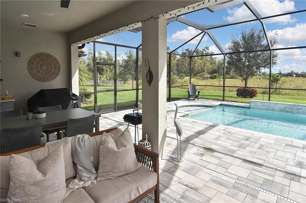 19375 Elston Way Estero, FL 33928 - Photo 39 of 50 a living room with furniture and a floor to ceiling window