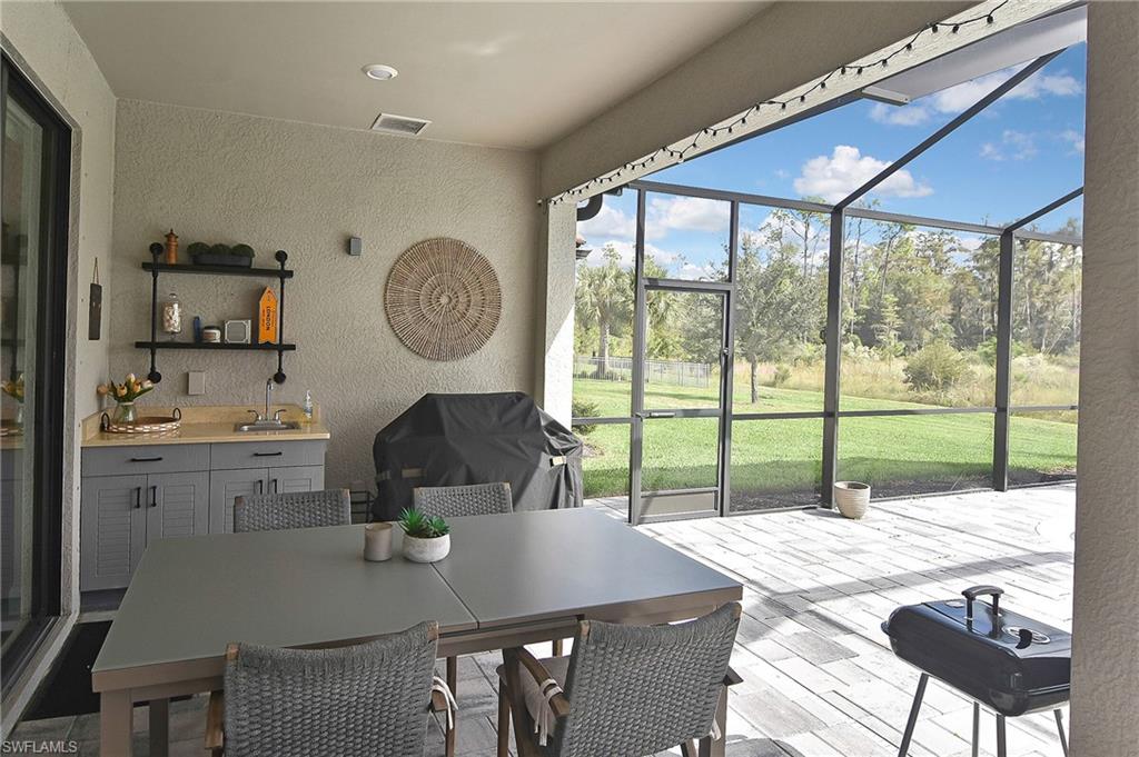 19375 Elston Way Estero, FL 33928 - Photo 40 of 50 a kitchen with a table chairs and a dining table