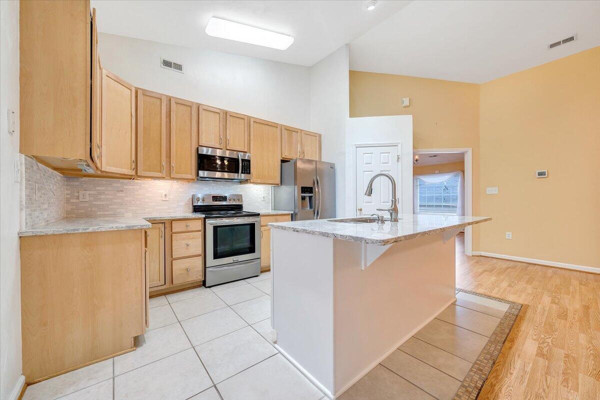 4202 Daugherty Road Salem, VA 24153 - Photo 11 of 38 a kitchen with granite countertop a stove top oven sink and cabinets