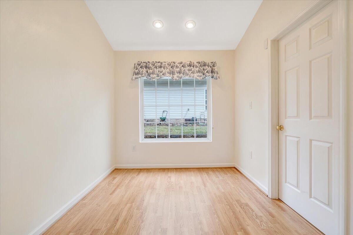 4202 Daugherty Road Salem, VA 24153 - Photo 14 of 38 an empty room with wooden floor and windows