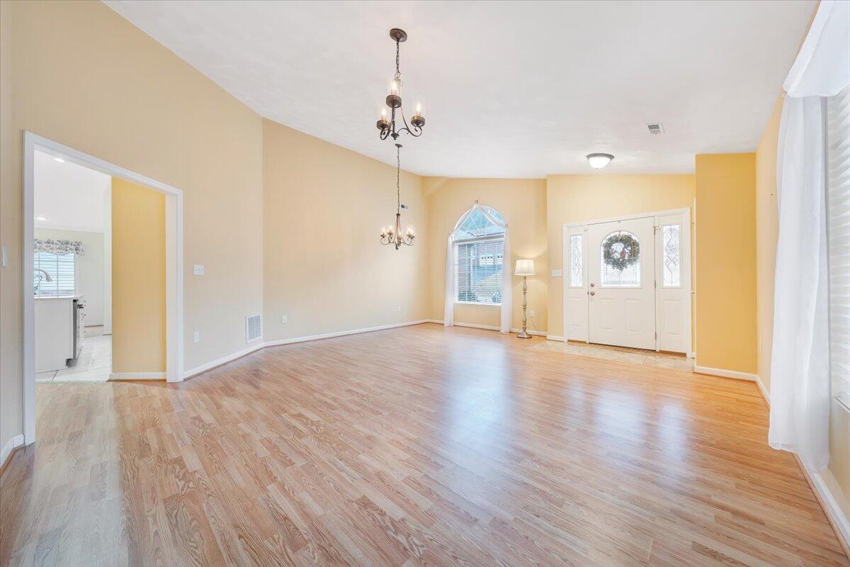 4202 Daugherty Road Salem, VA 24153 - Photo 4 of 38 a view of an empty room with wooden floor and a window