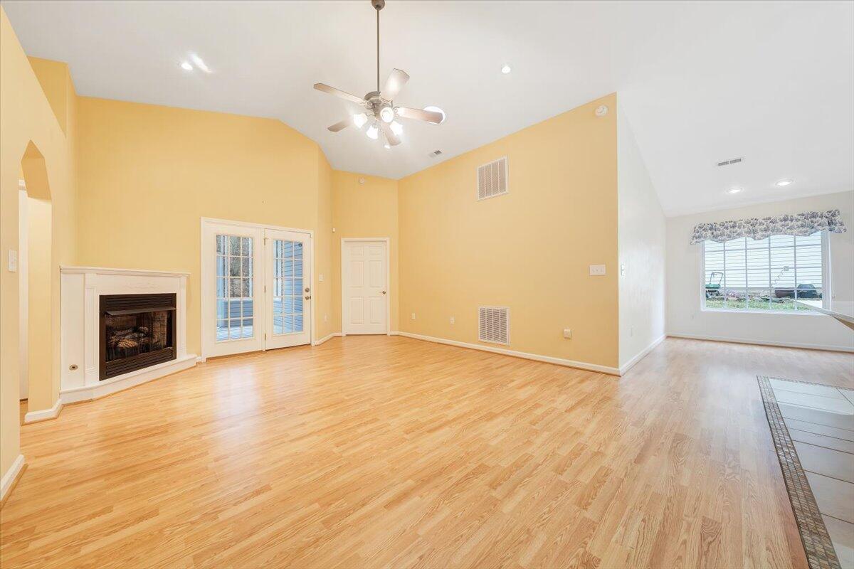 4202 Daugherty Road Salem, VA 24153 - Photo 7 of 38 an empty room with wooden floor fireplace and windows