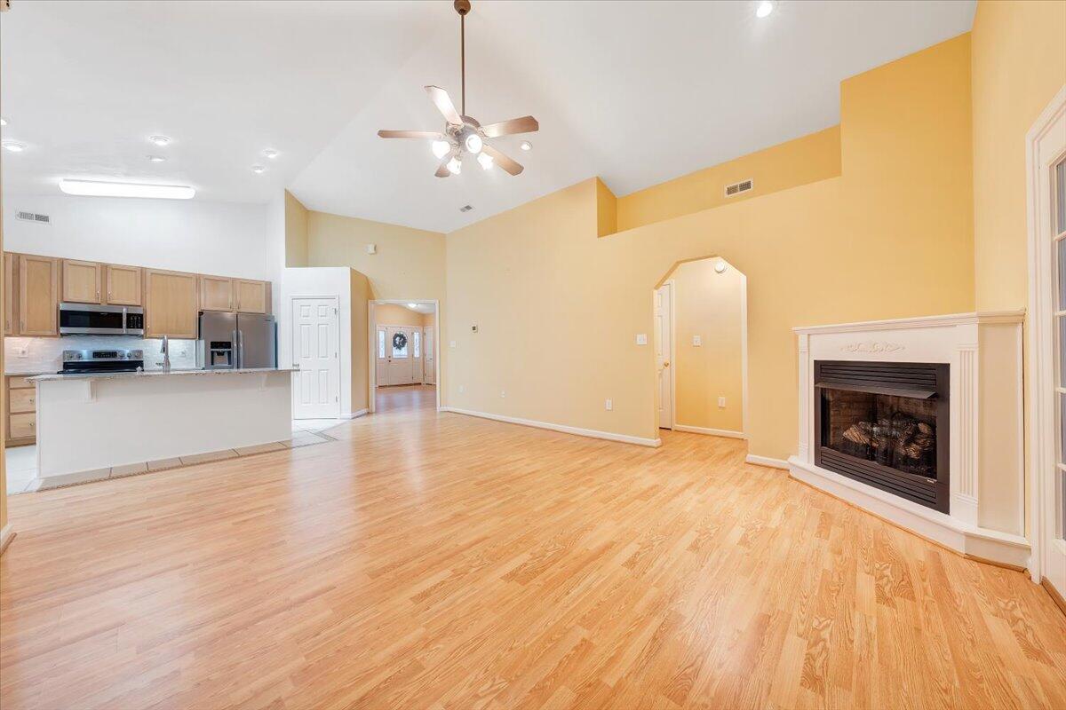 4202 Daugherty Road Salem, VA 24153 - Photo 9 of 38 a view of a livingroom with a fireplace a chandelier and wooden floor