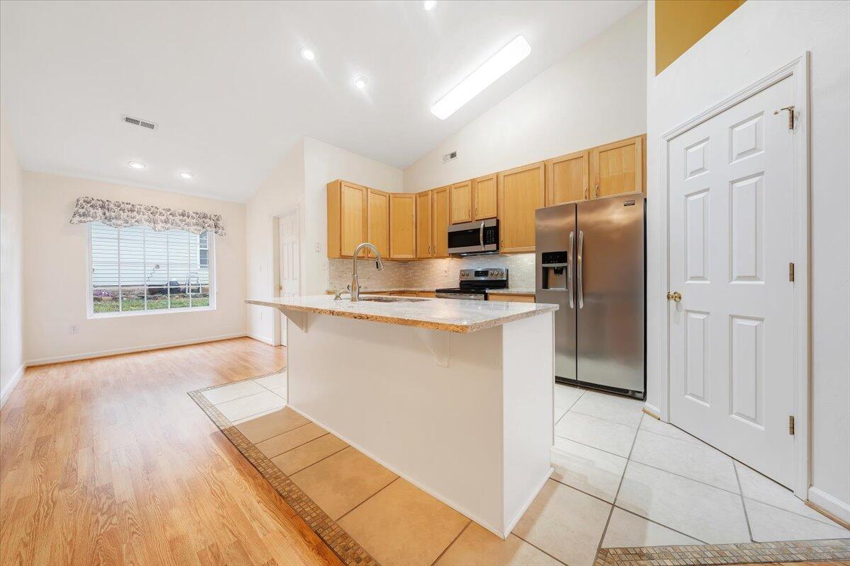 4202 Daugherty Road Salem, VA 24153 - Photo 10 of 38 a kitchen with kitchen island granite countertop a stove a refrigerator a sink a counter space and cabinets