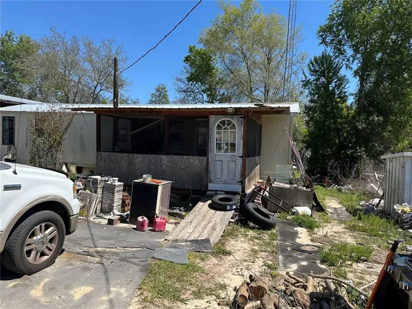 a view of a patio with table and chairs