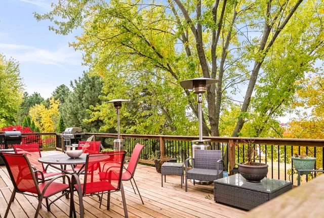 a spacious bathroom with a granite countertop double vanity sink a mirror and a shower