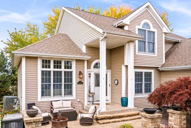 a kitchen with stainless steel appliances granite countertop a sink a stove cabinets and a window