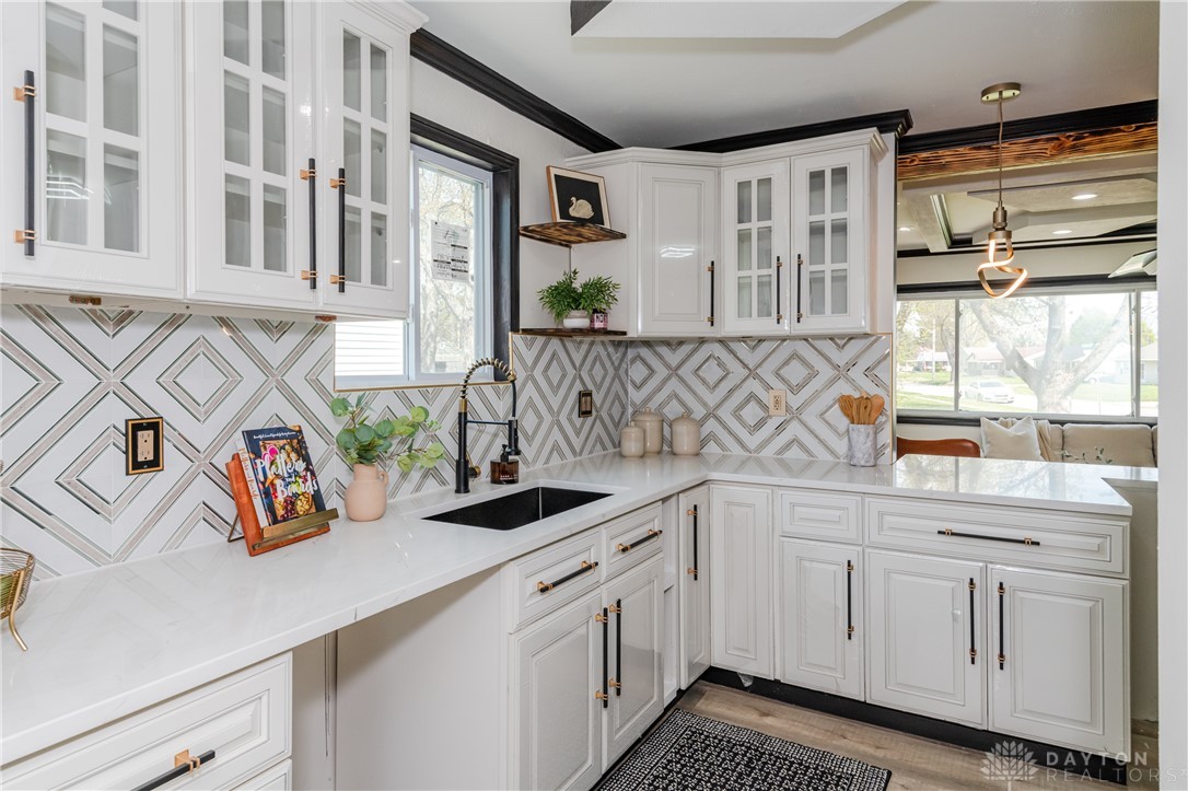 5240 Haverfield Road Dayton, OH 45432 - Photo 27 of 58 This modern kitchen features crisp white cabinetry and a geometric tile backsplash.