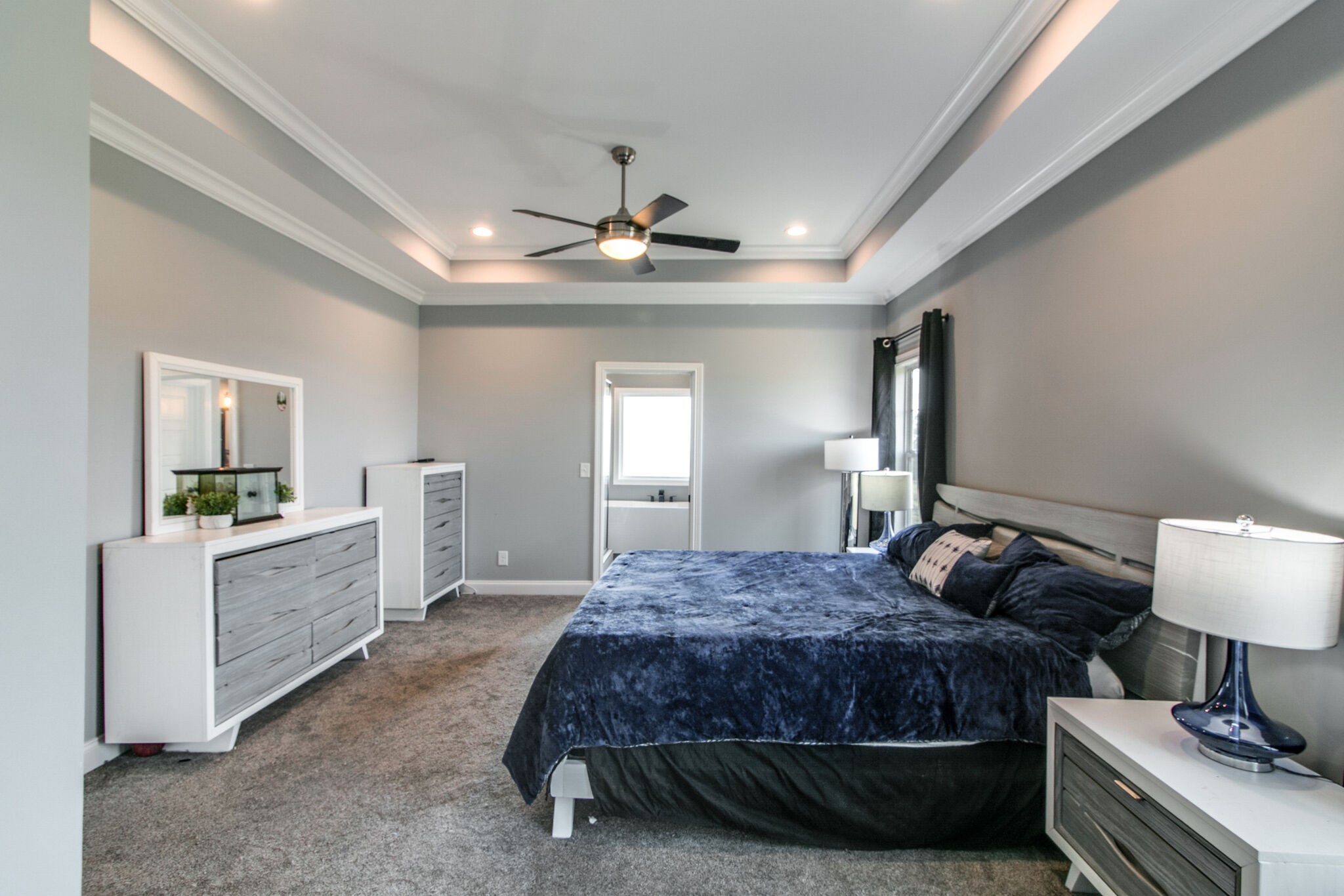 1940 Hickory Point Road Clarksville, TN 37043 - Photo 23 of 48 a spacious bedroom with a bed and a chandelier