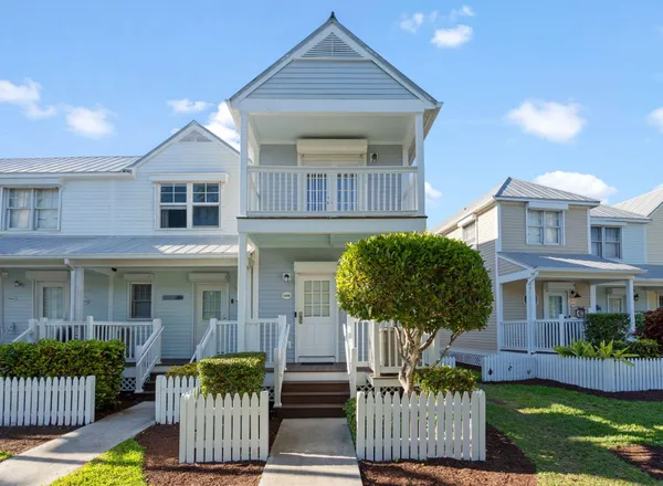 a front view of a house with a yard glass table and chairs
