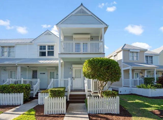 a front view of a house with a yard glass table and chairs