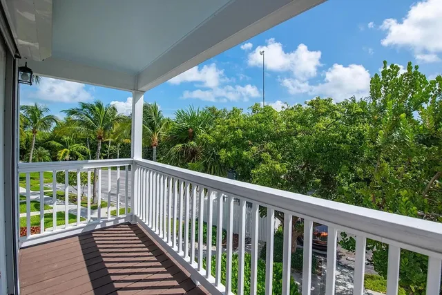 a view of a balcony with a yard